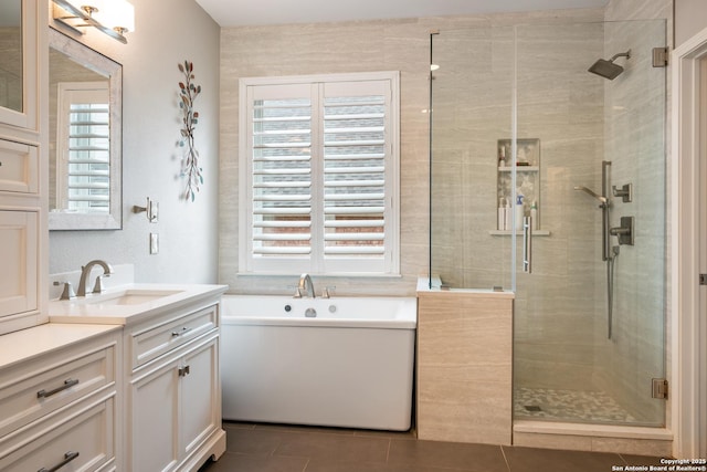 bathroom featuring tile patterned flooring, a wealth of natural light, and a shower stall