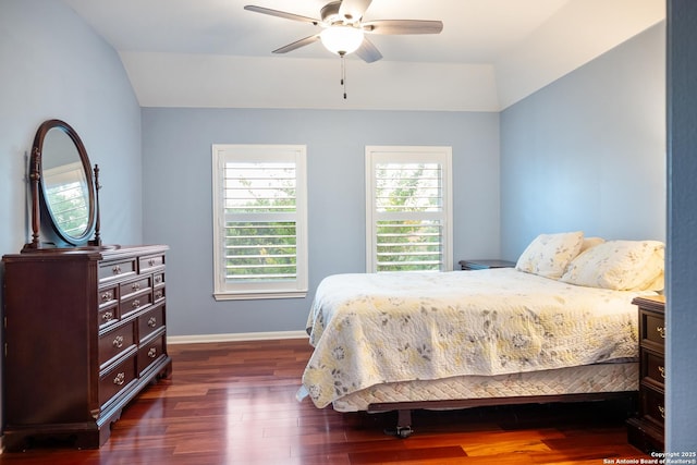 bedroom with dark wood-type flooring, baseboards, lofted ceiling, and multiple windows