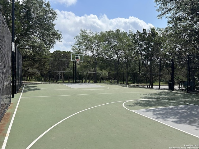 view of basketball court with fence and community basketball court