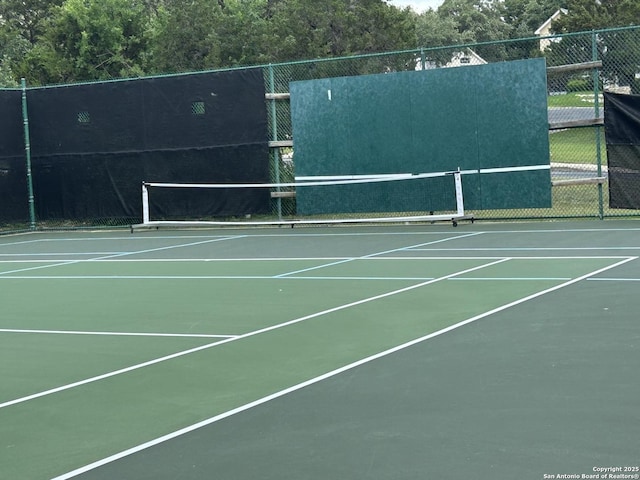 view of tennis court with fence