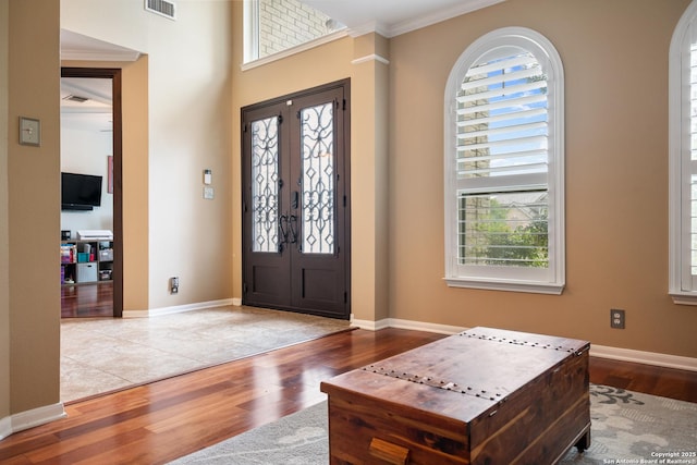 entryway featuring visible vents, wood finished floors, and a wealth of natural light