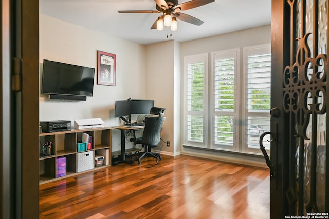 office space with a ceiling fan, baseboards, and wood finished floors