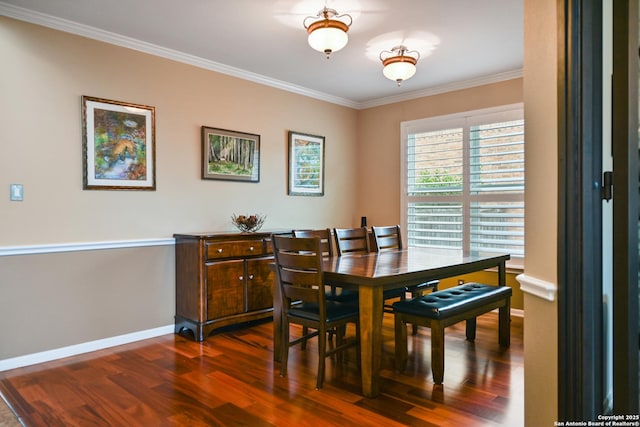 dining space featuring baseboards, ornamental molding, and dark wood-style flooring