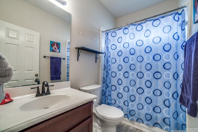 9110 Feather Blf, Helotes, TX 78023 - full bathroom featuring toilet, vanity, curtained shower, and wood finished floors