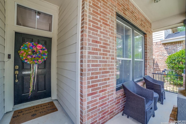 9110 Feather Blf, Helotes, TX 78023 - doorway to property featuring covered porch and brick siding