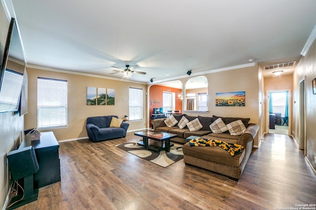 9110 Feather Blf, Helotes, TX 78023 - living area featuring ceiling fan, wood finished floors, arched walkways, baseboards, and plenty of natural light