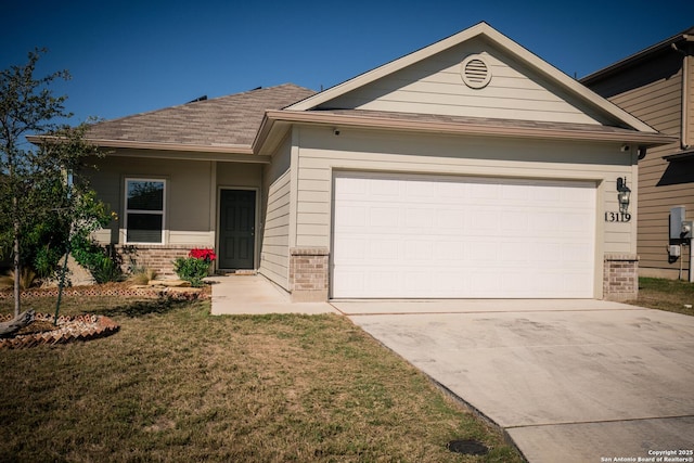 single story home featuring a garage, a front yard, driveway, and brick siding