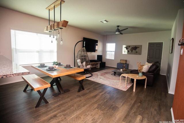 dining room with a ceiling fan, baseboards, visible vents, and dark wood finished floors