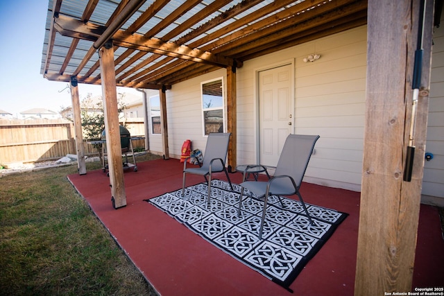 view of patio / terrace with a pergola and fence
