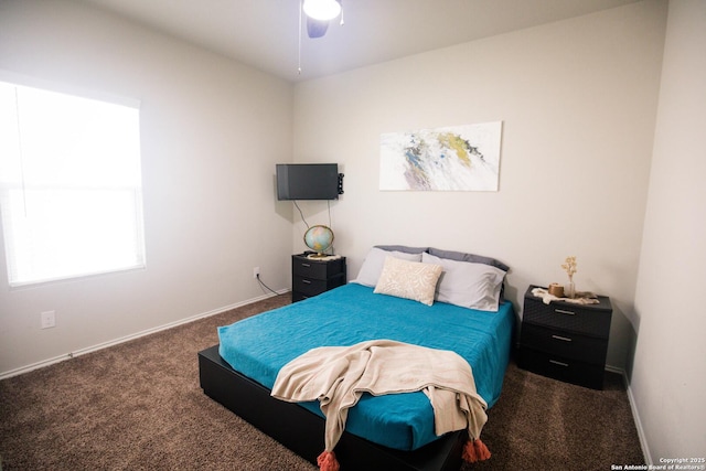 carpeted bedroom featuring baseboards and a ceiling fan