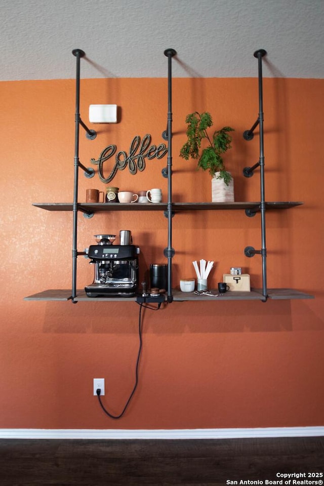 details featuring baseboards and a textured ceiling