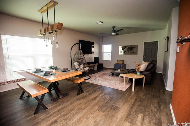 dining room featuring baseboards, a ceiling fan, and dark wood-style floors