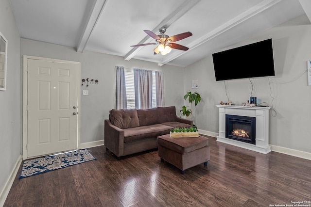5151 Village Grn, San Antonio, TX 78218 - living room featuring baseboards, a glass covered fireplace, ceiling fan, and dark wood-style floors