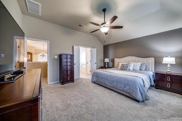carpeted bedroom with ensuite bathroom, lofted ceiling, ceiling fan, and visible vents