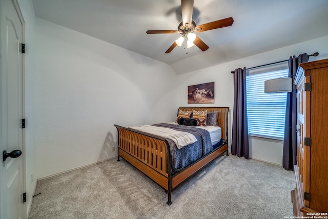 bedroom featuring carpet floors, baseboards, a ceiling fan, and lofted ceiling