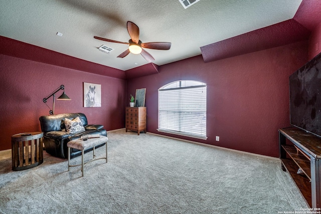living area with carpet, a ceiling fan, and visible vents