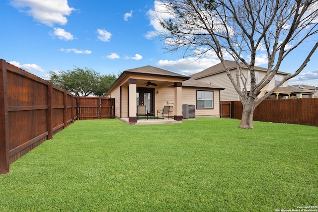10022 Carswell Peak, San Antonio, TX 78245 - rear view of house with central air condition unit, a lawn, a ceiling fan, and a fenced backyard