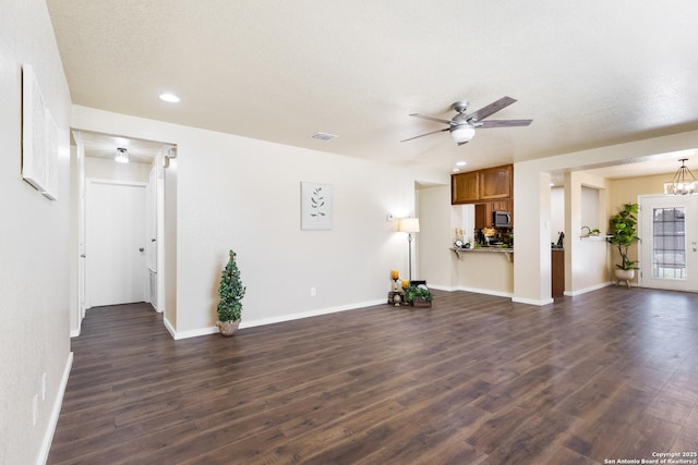 10022 Carswell Peak, San Antonio, TX 78245 - unfurnished living room with dark wood-style flooring, ceiling fan, recessed lighting, baseboards, and visible vents