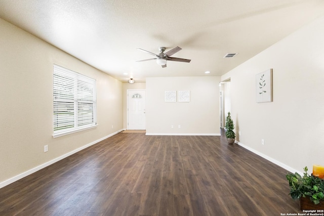 10022 Carswell Peak, San Antonio, TX 78245 - unfurnished living room featuring a ceiling fan, baseboards, visible vents, and dark wood-type flooring