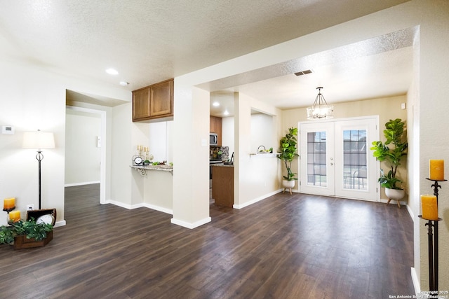 10022 Carswell Peak, San Antonio, TX 78245 - interior space with stainless steel microwave, brown cabinets, dark wood-style floors, and visible vents