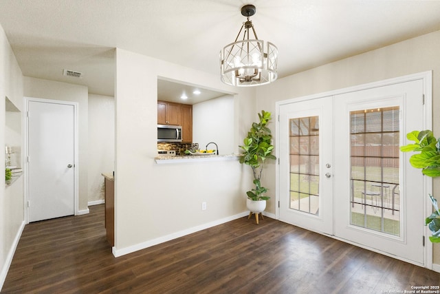 10022 Carswell Peak, San Antonio, TX 78245 - entryway with dark wood-style flooring, a notable chandelier, french doors, baseboards, and visible vents