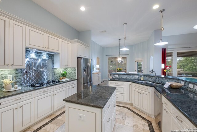 kitchen with recessed lighting, a sink, decorative backsplash, and stainless steel appliances