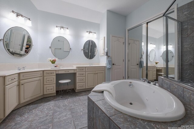 full bath featuring vanity, a whirlpool tub, and a shower