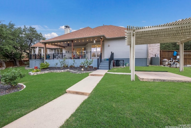view of front of property featuring ceiling fan, a chimney, a front yard, central air condition unit, and a pergola
