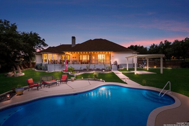 outdoor pool with a lawn, a patio area, fence, and a pergola