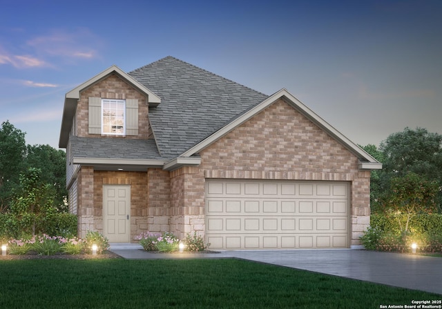 view of front of home featuring an attached garage, driveway, stone siding, and a front yard