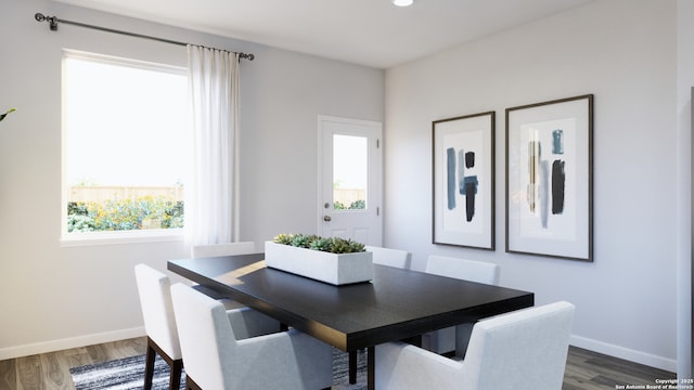 dining area featuring baseboards, plenty of natural light, and wood finished floors