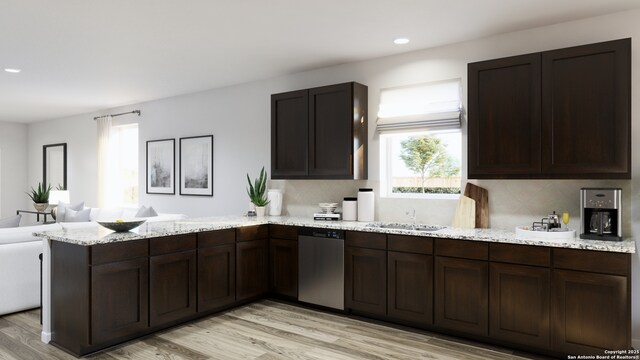 kitchen featuring a wealth of natural light, light wood-type flooring, a peninsula, and dishwasher