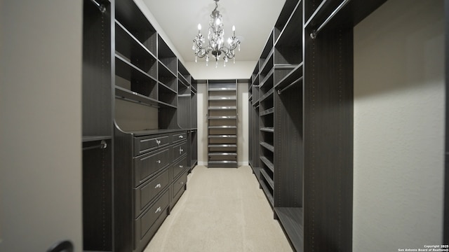 spacious closet featuring light colored carpet and an inviting chandelier