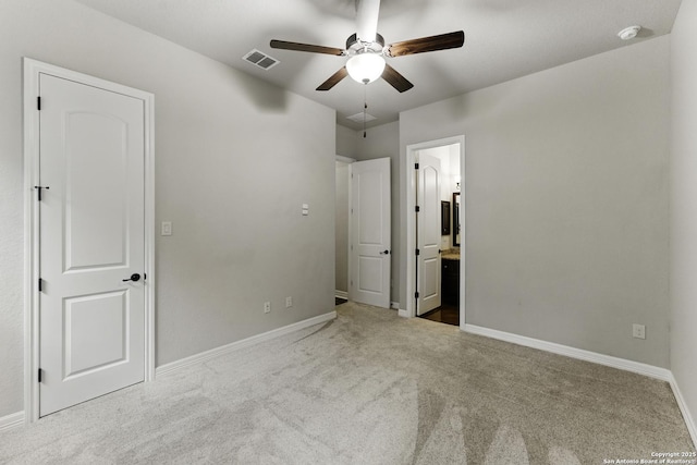 unfurnished bedroom featuring baseboards, carpet flooring, and visible vents
