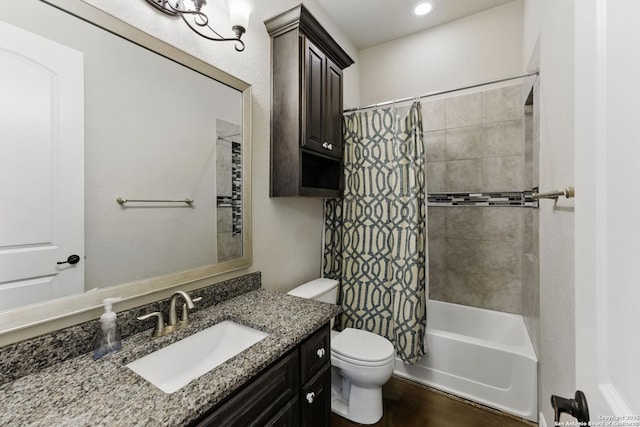full bathroom with toilet, shower / bath combo with shower curtain, and vanity