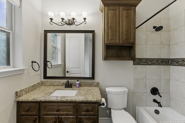 bathroom with shower / bathtub combination, toilet, and vanity