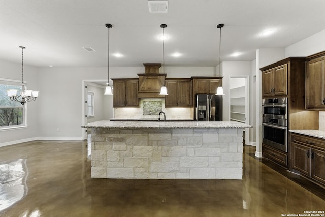 kitchen featuring stainless steel appliances, visible vents, tasteful backsplash, and finished concrete flooring