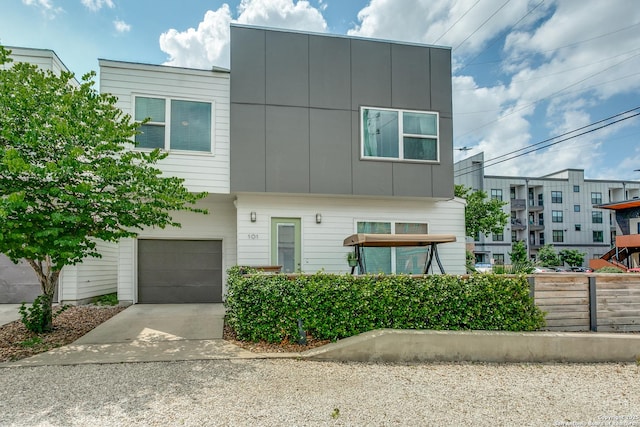 contemporary home with a garage, board and batten siding, and driveway