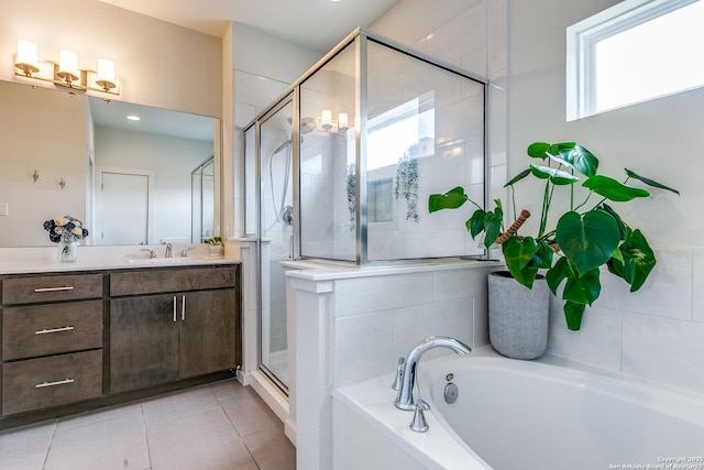 bathroom featuring vanity, a bath, a stall shower, and tile patterned flooring