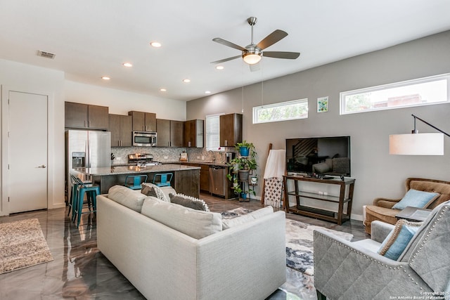 living area featuring visible vents, a ceiling fan, recessed lighting, and marble finish floor