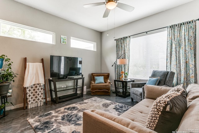 living room with baseboards and a ceiling fan