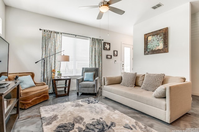 living room featuring visible vents and ceiling fan