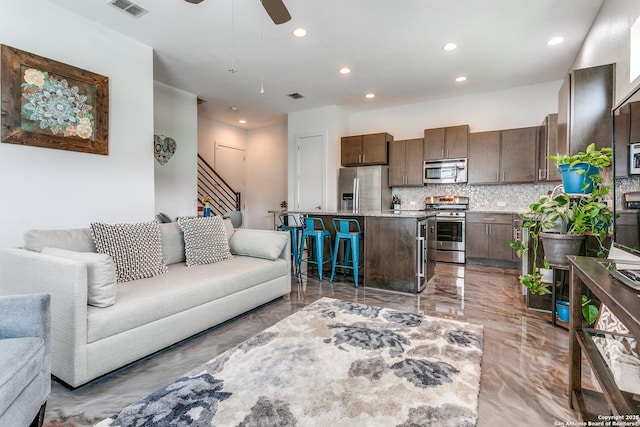 living room featuring recessed lighting, visible vents, and marble finish floor