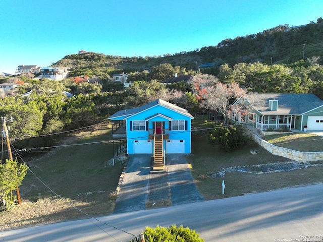 726 Barbara Dr, Canyon Lake, TX 78133 - view of front of home with an attached garage, driveway, and stairway