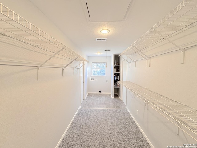 726 Barbara Dr, Canyon Lake, TX 78133 - spacious closet featuring light colored carpet, visible vents, and attic access