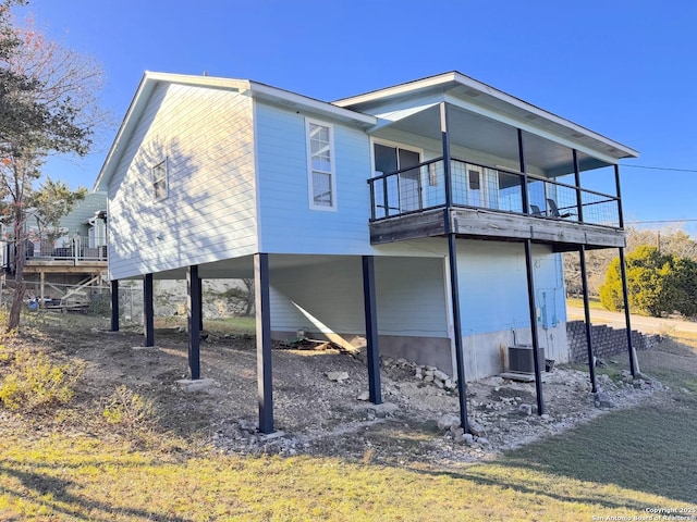 726 Barbara Dr, Canyon Lake, TX 78133 - back of property with central air condition unit, a carport, and a balcony