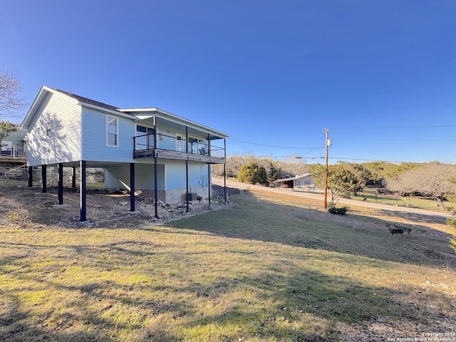 726 Barbara Dr, Canyon Lake, TX 78133 - rear view of house featuring a lawn, a balcony, and a carport