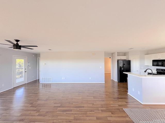 726 Barbara Dr, Canyon Lake, TX 78133 - unfurnished living room featuring visible vents, a sink, ceiling fan, and wood finished floors