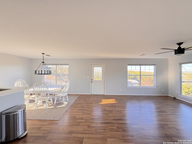 726 Barbara Dr, Canyon Lake, TX 78133 - unfurnished dining area featuring dark wood-type flooring, a ceiling fan, and baseboards