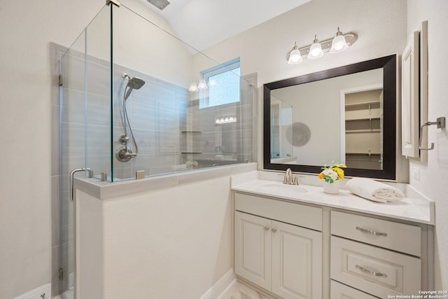 bathroom with vanity and a stall shower